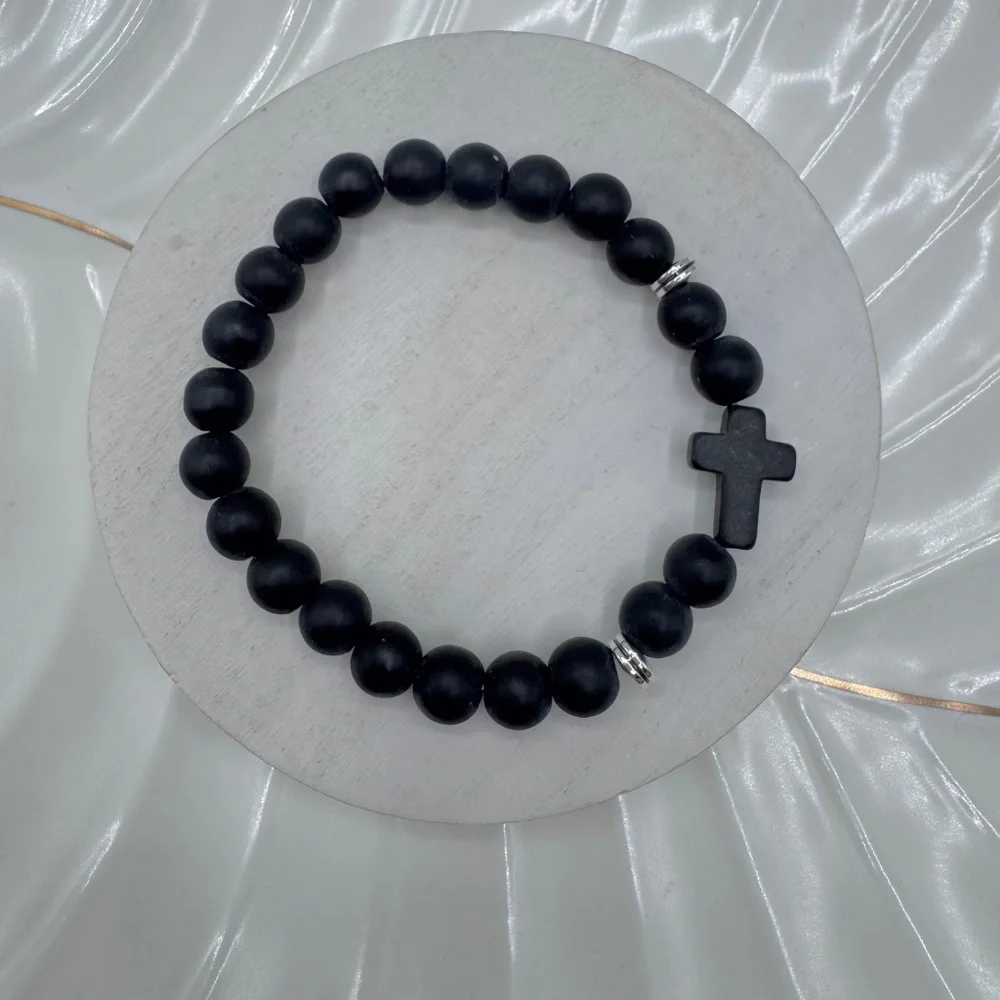 This elegant bracelet features smooth matte black beads paired with a bold black